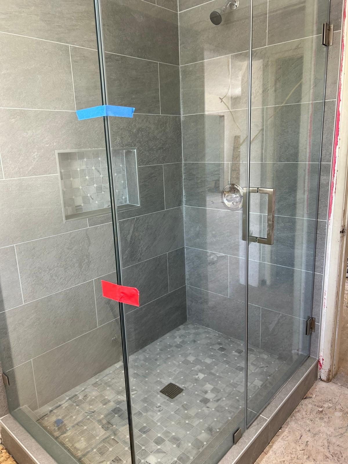 Tiled bathroom shower with glass enclosure